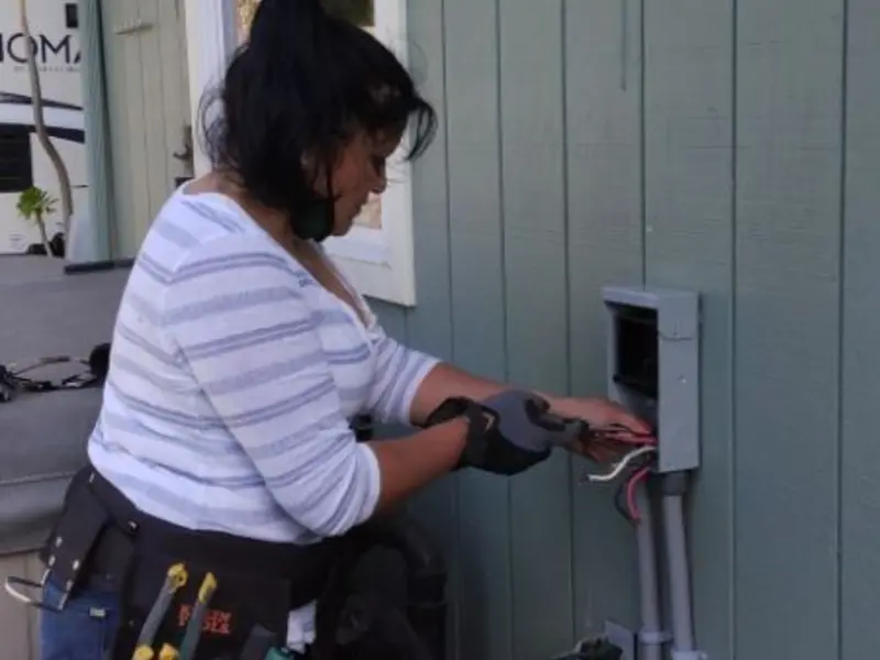 Licensed electrician wiring an exterior subpanel in Groton